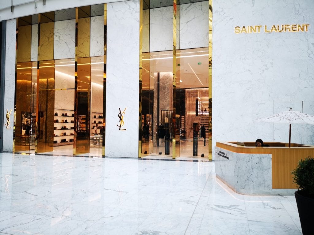 Luxusgeschäft mit weiß-goldener Fassade, Shopping-Eingang